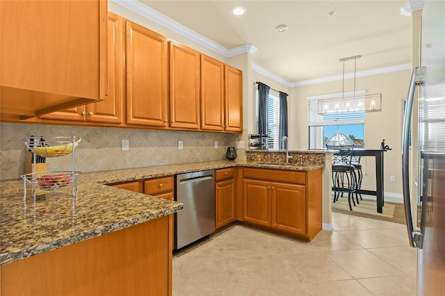 kitchen featuring kitchen peninsula, appliances with stainless steel finishes, crown molding, decorative light fixtures, and stone countertops