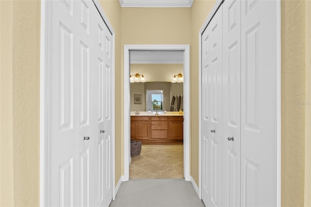 corridor featuring light carpet and ornamental molding