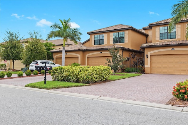 mediterranean / spanish home featuring a garage