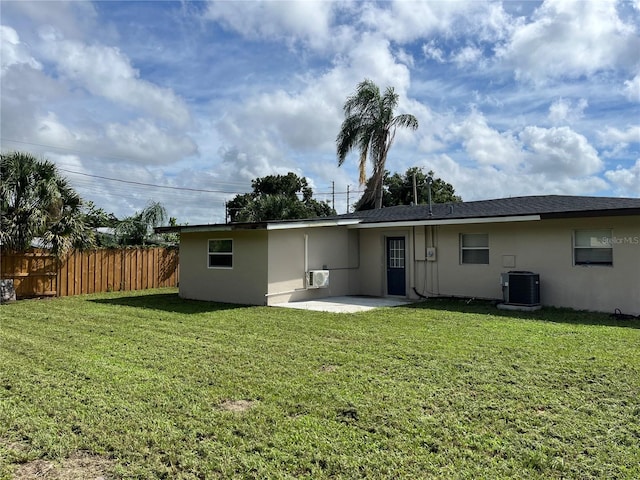 back of house with a patio area, a yard, and central air condition unit