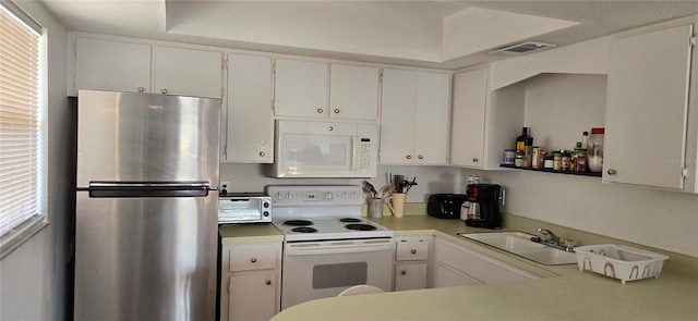 kitchen featuring white appliances, a wealth of natural light, white cabinetry, and sink