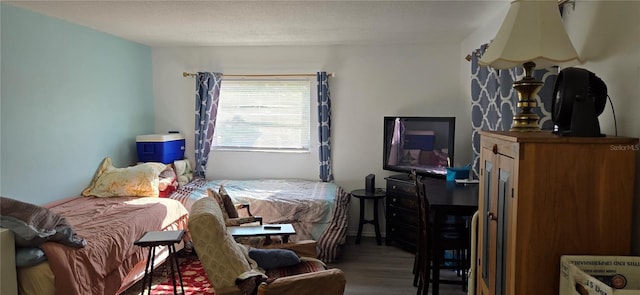 bedroom featuring hardwood / wood-style floors and a textured ceiling