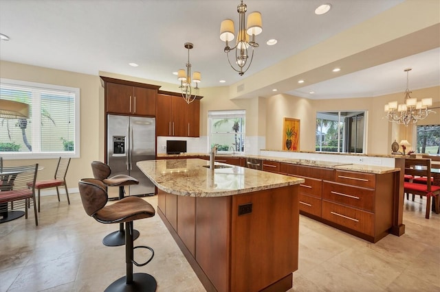 kitchen featuring a notable chandelier, a healthy amount of sunlight, and stainless steel fridge with ice dispenser