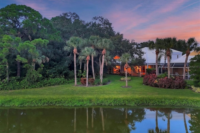 exterior space featuring a yard and a water view