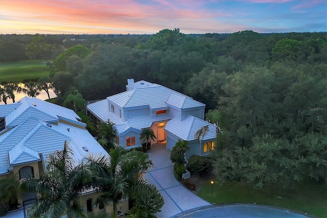 drone / aerial view featuring a wooded view