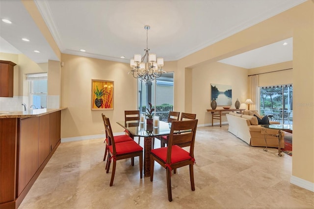 dining space with crown molding, baseboards, and an inviting chandelier