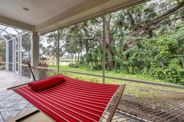 unfurnished sunroom featuring a water view