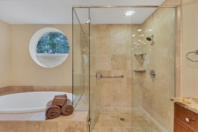 bathroom featuring vanity, a shower stall, and a bath