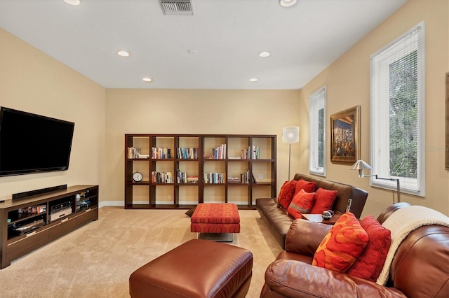 living area featuring light colored carpet, visible vents, baseboards, and recessed lighting