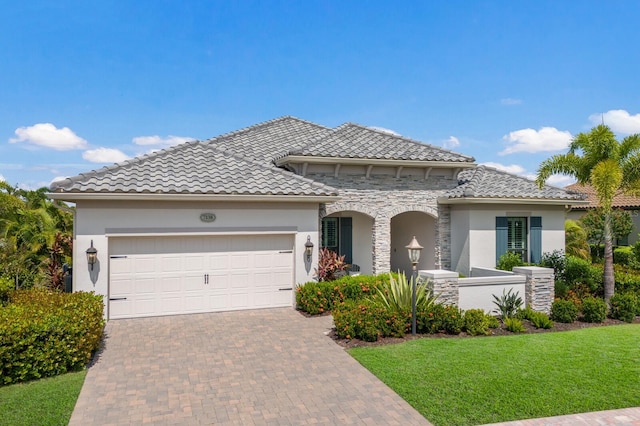 view of front of home with a garage and a front yard