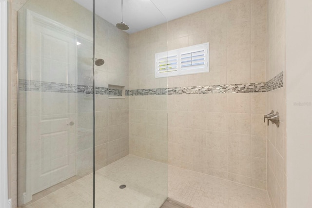 bathroom with a tile shower