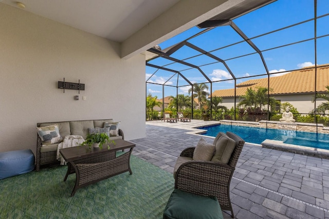 view of swimming pool with glass enclosure, a patio area, an outdoor hangout area, and pool water feature