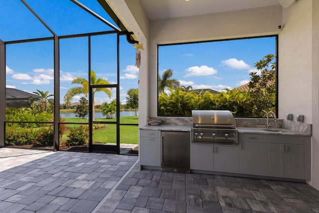 unfurnished sunroom with plenty of natural light, sink, and a water view