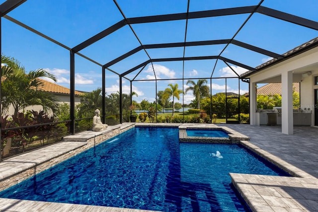 view of pool with an in ground hot tub, glass enclosure, and a patio area