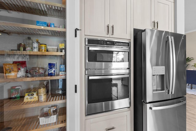 kitchen featuring stainless steel appliances and light hardwood / wood-style floors