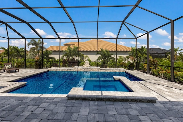 view of swimming pool with a lanai, a patio, and an in ground hot tub