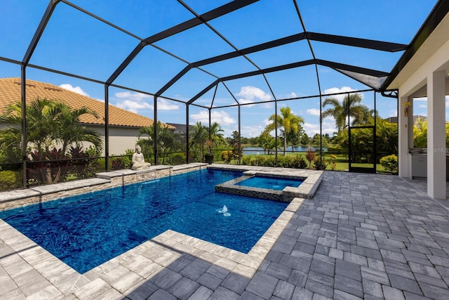 view of pool featuring glass enclosure, a patio, and an in ground hot tub