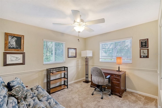 carpeted home office featuring ceiling fan