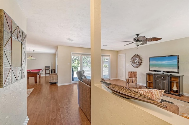 living room featuring ceiling fan, wood-type flooring, and billiards