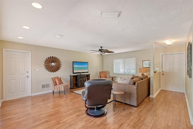 living room with ceiling fan and light hardwood / wood-style floors