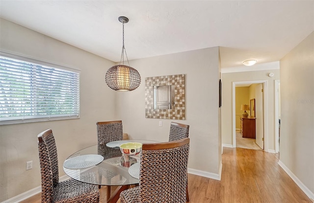 1833 Sandalwood Dr, Sarasota, FL 34231 - dining room with light wood-type flooring and baseboards