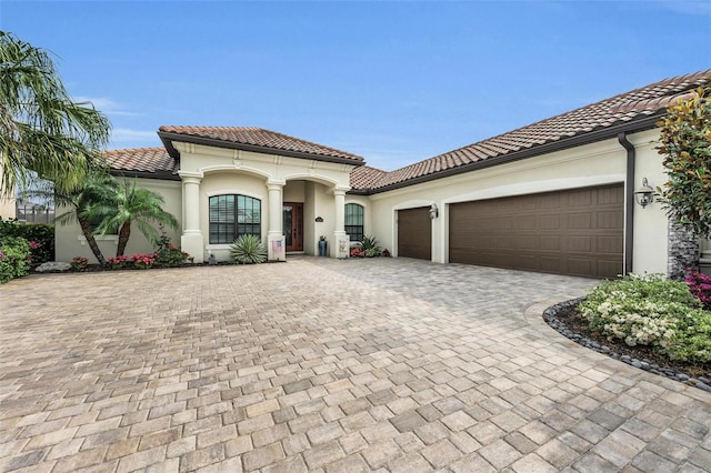 mediterranean / spanish-style home featuring a garage