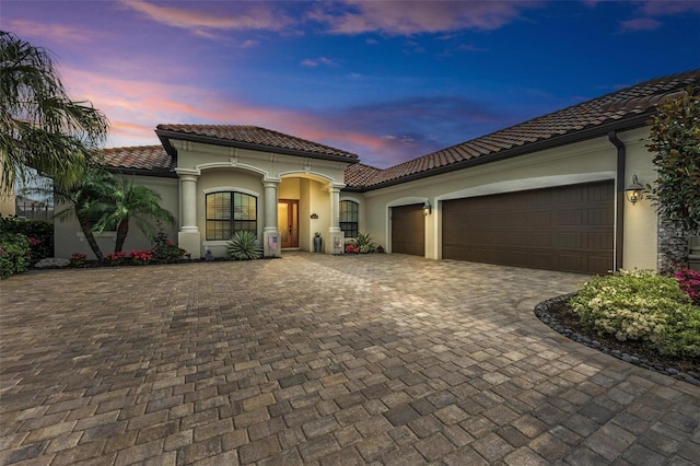 mediterranean / spanish-style house with a garage