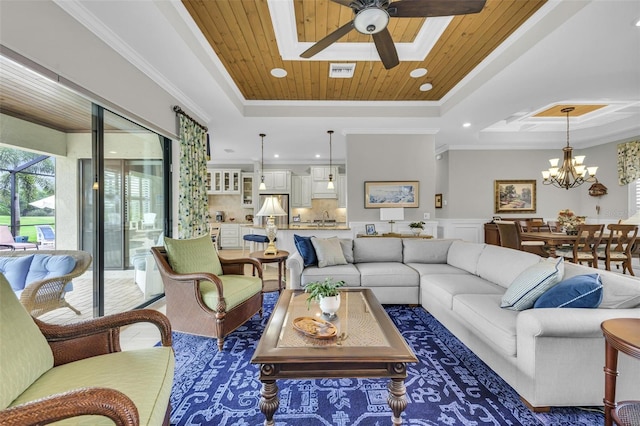 living room with ceiling fan with notable chandelier, wood ceiling, crown molding, and a tray ceiling