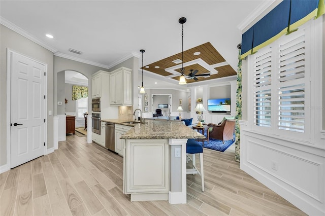 kitchen with light hardwood / wood-style flooring, ceiling fan, plenty of natural light, and sink