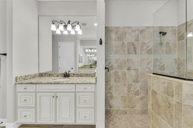 bathroom with vanity and tiled shower