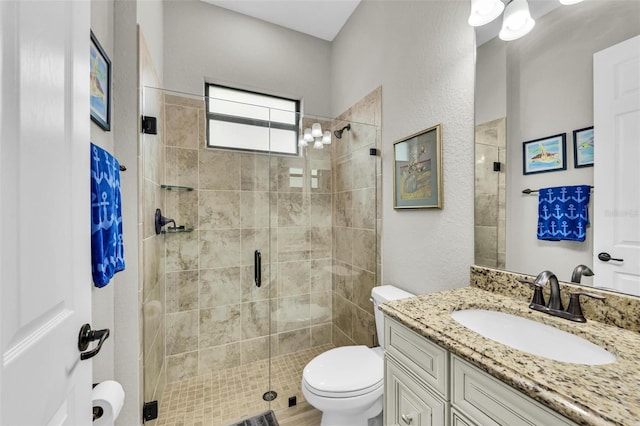 bathroom with vanity, toilet, and walk in shower