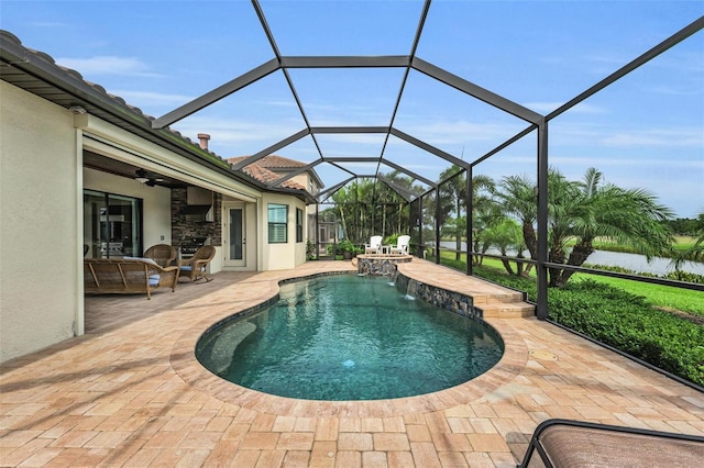 view of pool featuring pool water feature, ceiling fan, a patio area, and a lanai