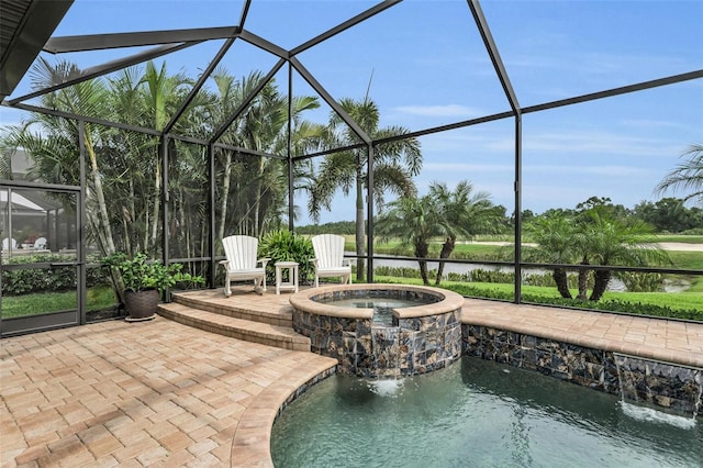 view of pool with a patio area, an in ground hot tub, pool water feature, and a lanai