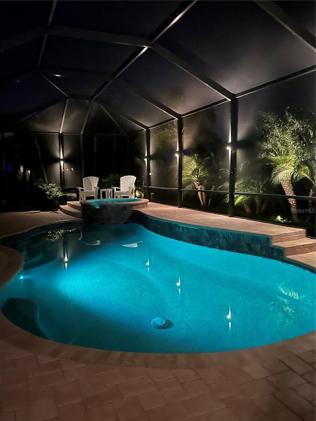 view of swimming pool featuring a lanai and a patio