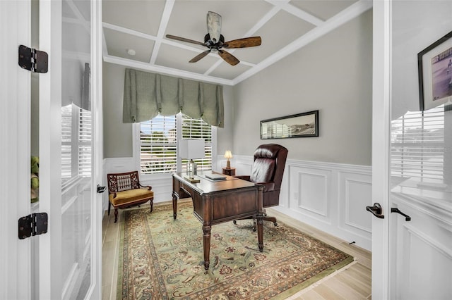 office space with ornamental molding, coffered ceiling, wood-type flooring, and ceiling fan