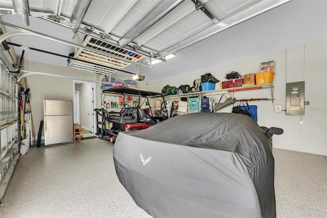 garage featuring a garage door opener, stainless steel refrigerator, and electric panel