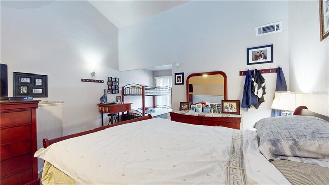 bedroom featuring high vaulted ceiling