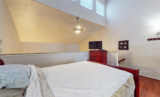 bedroom featuring vaulted ceiling and dark hardwood / wood-style floors