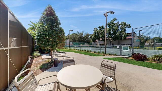 view of patio featuring tennis court