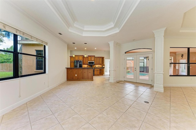 unfurnished living room with french doors, light tile patterned flooring, ornamental molding, and a tray ceiling