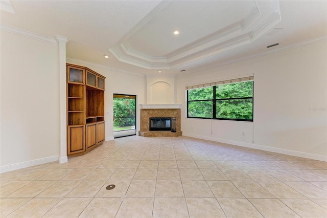 unfurnished living room featuring light tile patterned floors, a tray ceiling, and crown molding