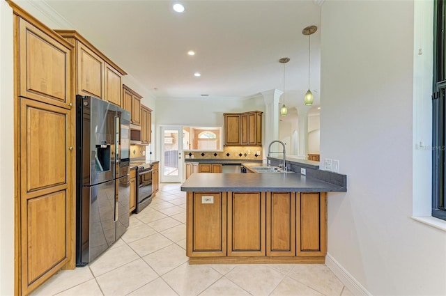 kitchen with stainless steel appliances, decorative light fixtures, sink, and kitchen peninsula