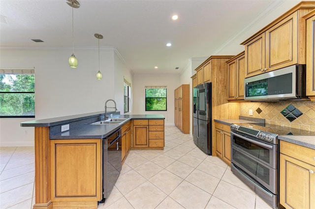 kitchen with decorative light fixtures, a kitchen island, appliances with stainless steel finishes, ornamental molding, and sink