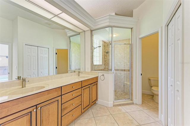 bathroom with toilet, tile patterned floors, an enclosed shower, vanity, and crown molding