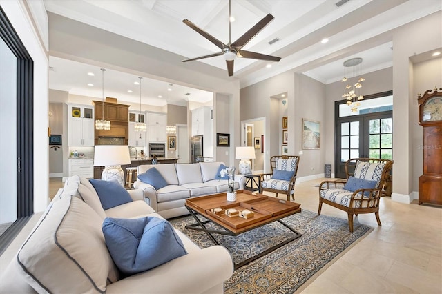 living room featuring a high ceiling, french doors, ornamental molding, ceiling fan with notable chandelier, and sink