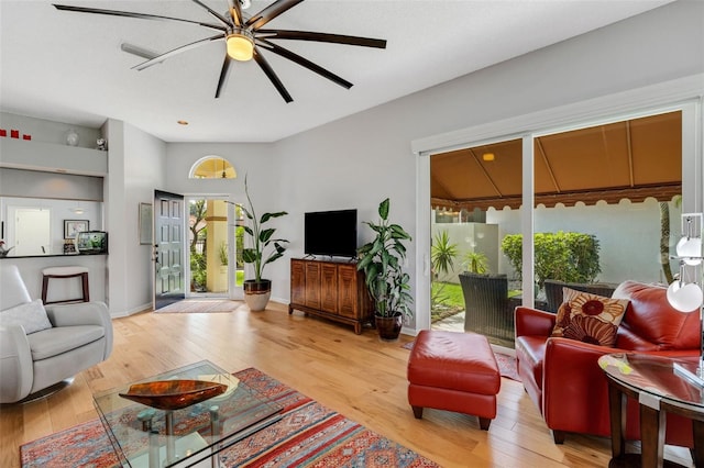 living room featuring ceiling fan and light hardwood / wood-style floors