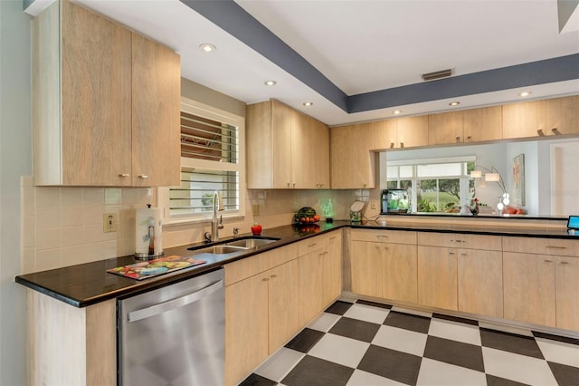 kitchen featuring dishwasher, tasteful backsplash, light brown cabinetry, and sink