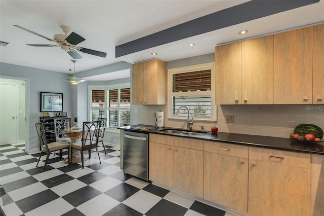 kitchen featuring plenty of natural light, stainless steel dishwasher, ceiling fan, and sink