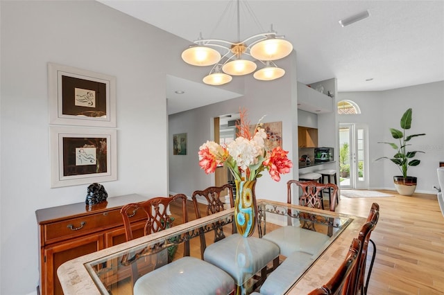 dining space featuring a chandelier and light hardwood / wood-style floors