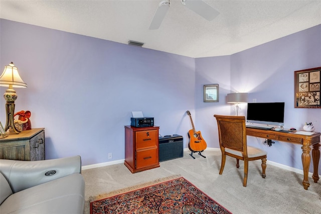 office featuring a textured ceiling, light colored carpet, and ceiling fan